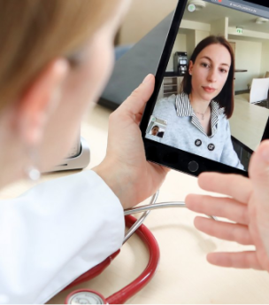 A doctor talks in a video call