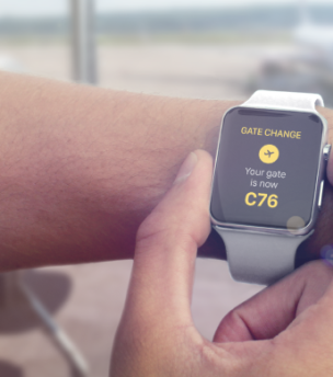 a smartwatch that shows an airport gate change